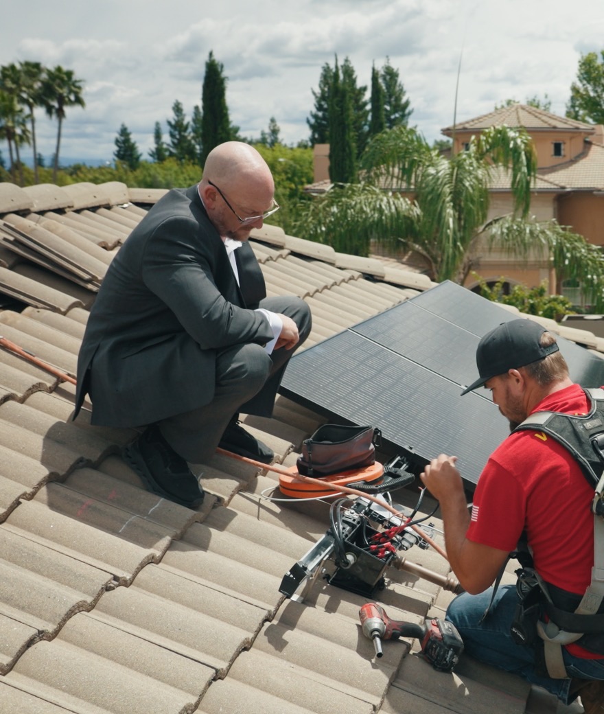 Brett from Westhaven and an installer reviewing a rooftop solar install on a Northern California home.